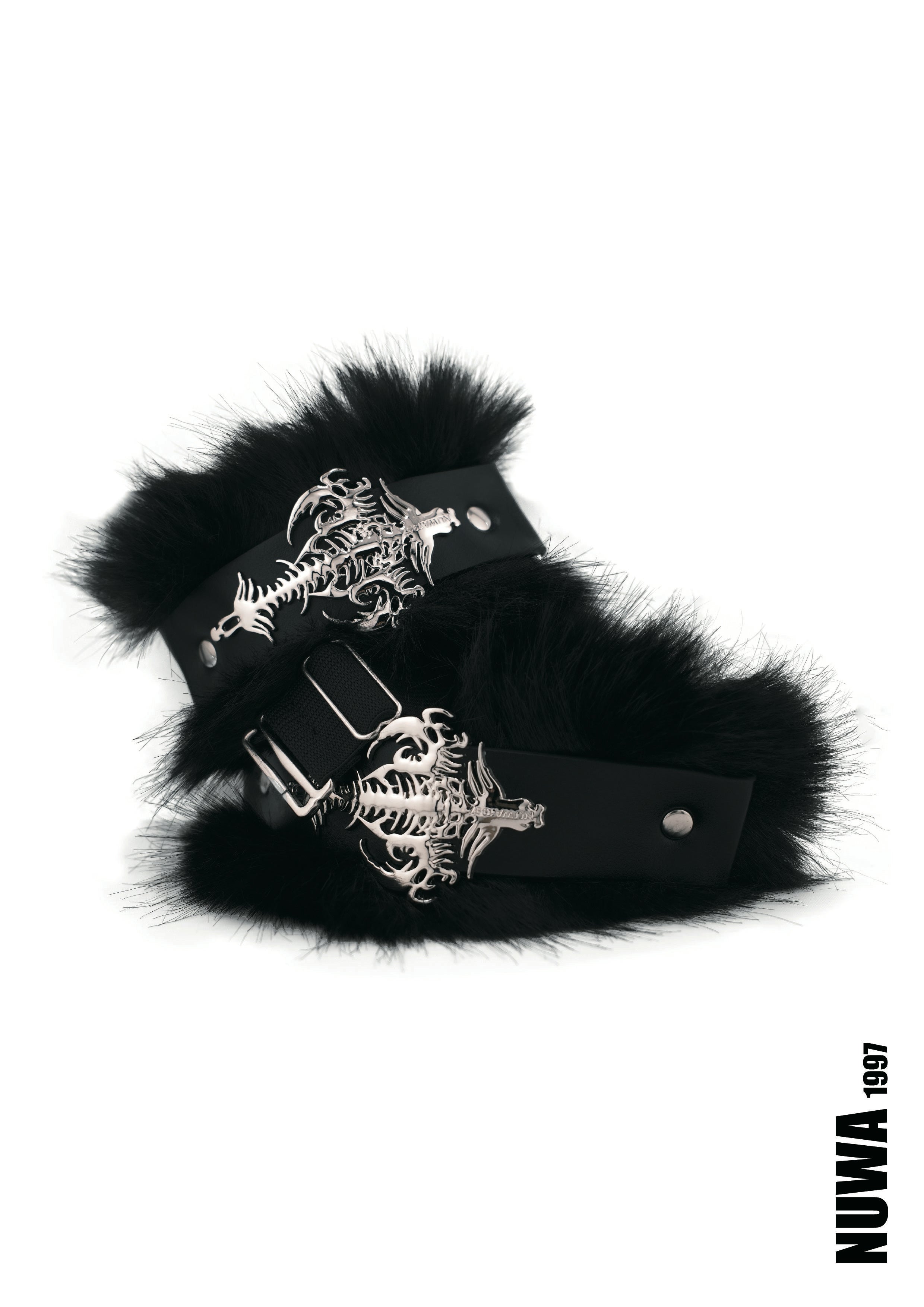 Black faux fur cuffs with silver-toned metal hardware featuring a cross and skeleton design, displayed on a white background with a NUWA 1997 logo in the bottom right corner.